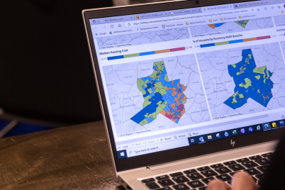 A laptop showing comparative community maps