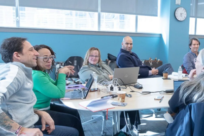 A group of people around a conference table