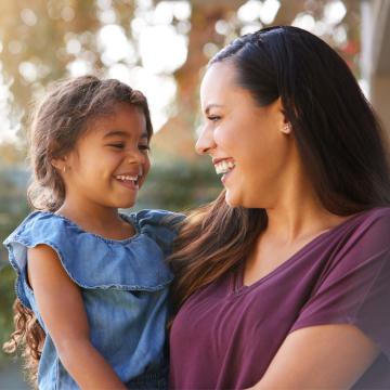 Woman holding a child and smiling